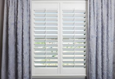 ShutterSMART composite shutters with blue textured drapery