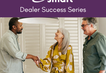 Dealer shaking hands with smiling customer with white Shuttersmart shutters behind.