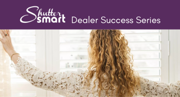 Woman looking out window with white Shuttersmart Shutters